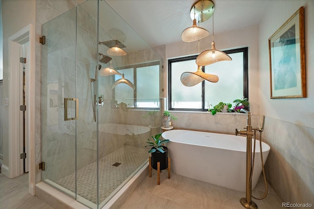 10701 Flagler Dr, Parker, CO 80134 - full bath featuring a soaking tub, tile patterned floors, a stall shower, and tile walls