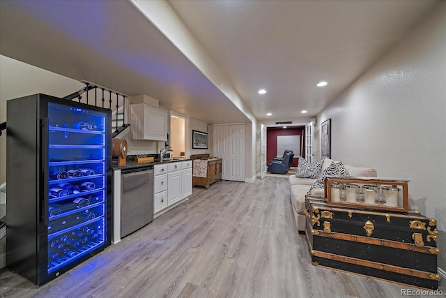 10701 Flagler Dr, Parker, CO 80134 - kitchen featuring white cabinetry, light wood-style flooring, dark countertops, wine cooler, and a sink