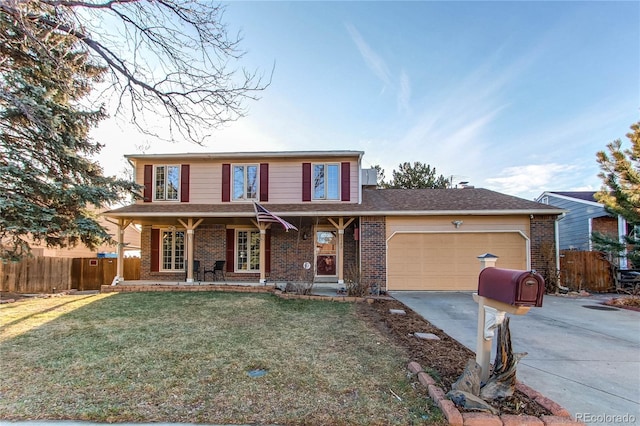 traditional home featuring a front yard, fence, and brick siding