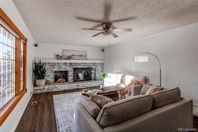 living room with a fireplace, visible vents, wood finished floors, and ornamental molding