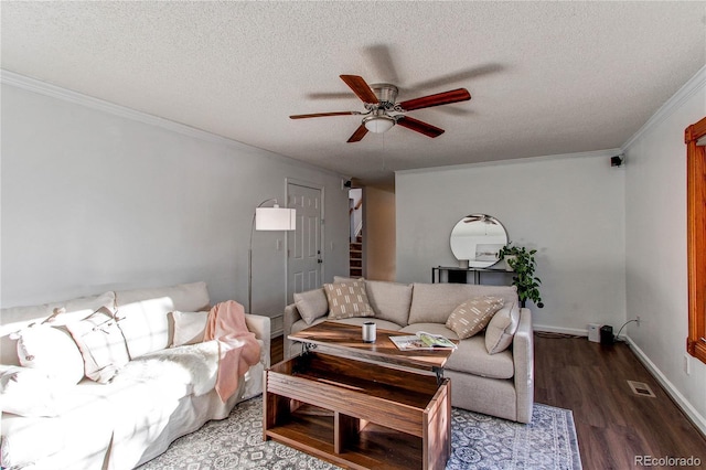 living room with a textured ceiling, wood finished floors, visible vents, stairs, and ornamental molding