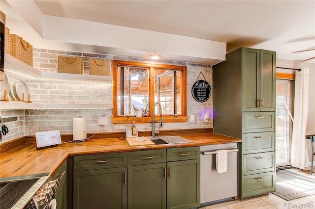 kitchen featuring butcher block counters, green cabinetry, and a sink