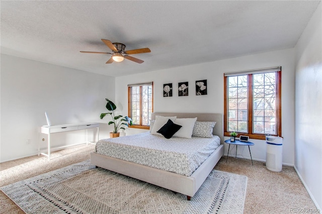 bedroom featuring carpet flooring, ceiling fan, a textured ceiling, and baseboards