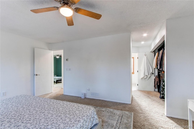 bedroom with baseboards, visible vents, a ceiling fan, a textured ceiling, and carpet floors