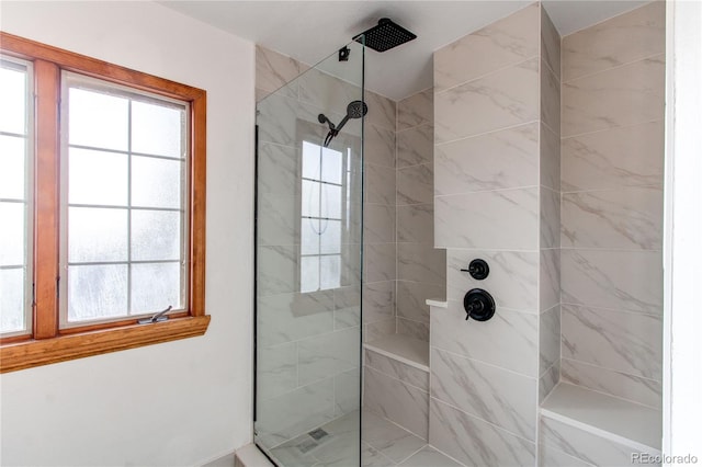 bathroom featuring a healthy amount of sunlight and walk in shower