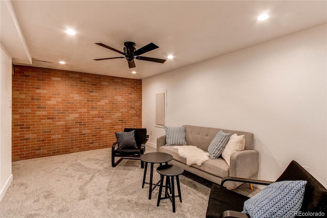 carpeted living room featuring recessed lighting, ceiling fan, and brick wall