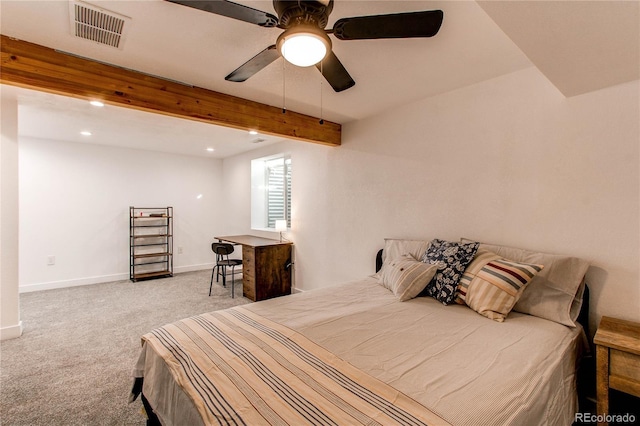 bedroom with carpet floors, beamed ceiling, visible vents, and baseboards