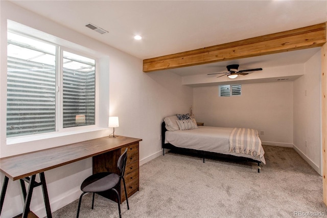 bedroom with beamed ceiling, carpet, visible vents, and baseboards