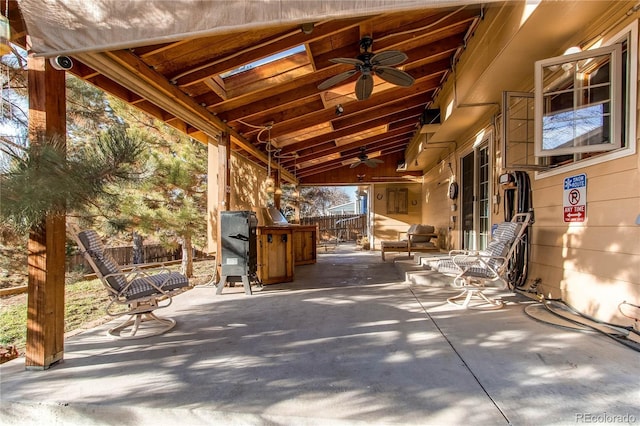 view of patio / terrace with ceiling fan and fence