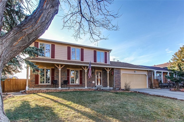 traditional home with brick siding, a porch, an attached garage, and fence