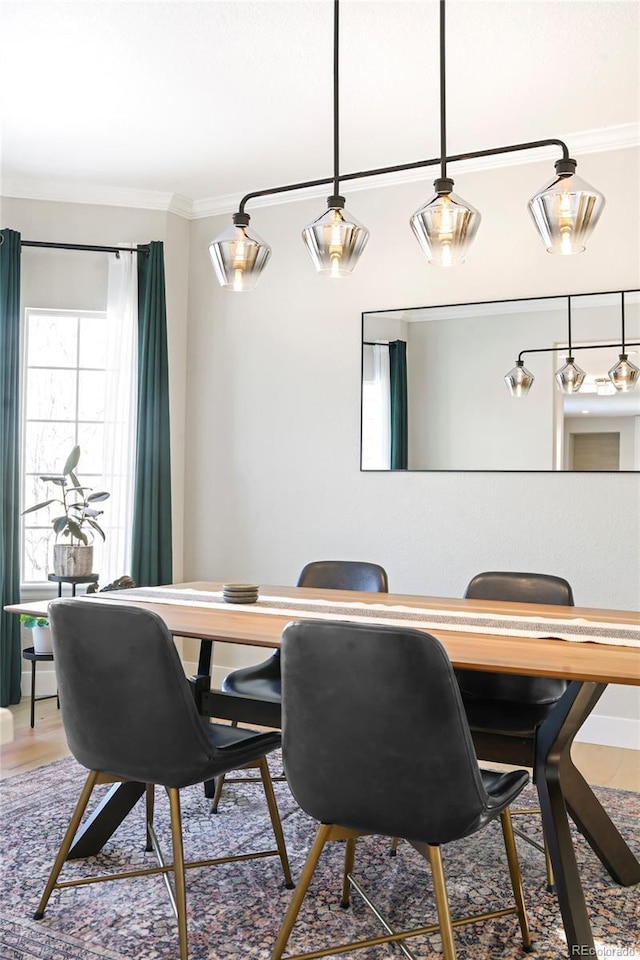 dining space featuring crown molding and wood-type flooring