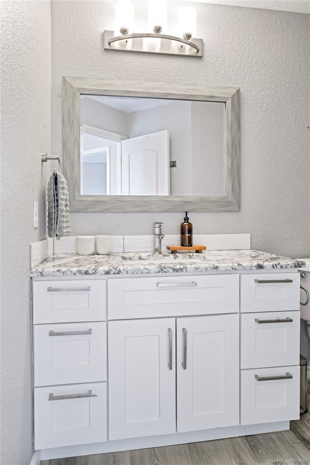 bathroom featuring vanity and hardwood / wood-style floors