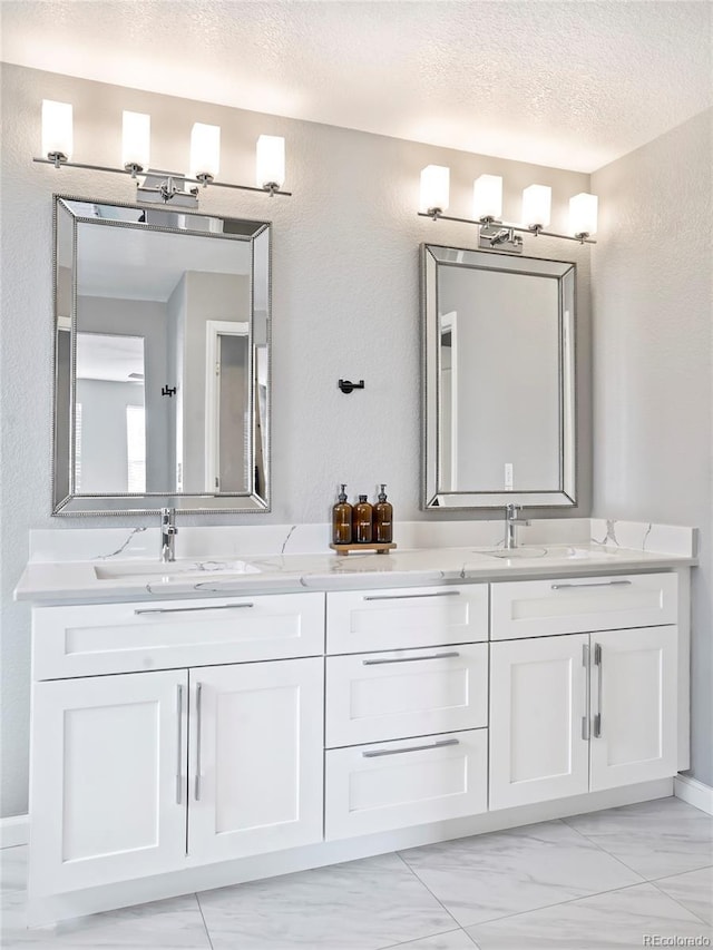 bathroom with vanity and a textured ceiling