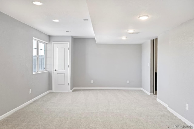 unfurnished room with light carpet