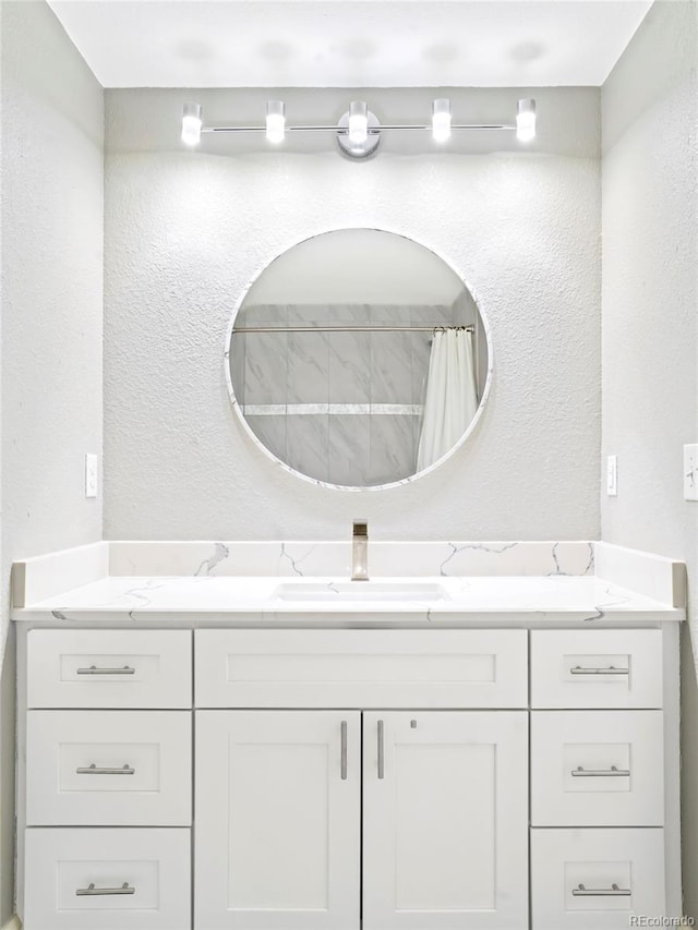 bathroom featuring vanity and a shower with shower curtain