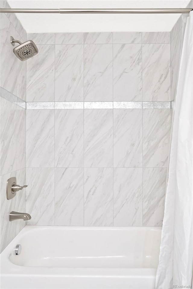 bathroom with shower / bathtub combination with curtain