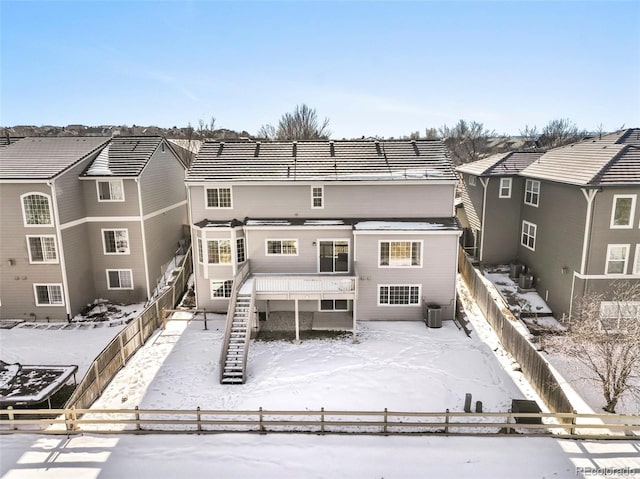 snow covered house with cooling unit