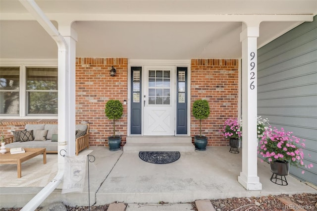 9926 W Nova Pl, Littleton, CO 80127 - entrance to property featuring covered porch and brick siding
