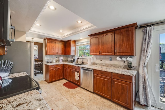 9926 W Nova Pl, Littleton, CO 80127 - kitchen with stainless steel appliances, a tray ceiling, recessed lighting, light stone countertops, and backsplash