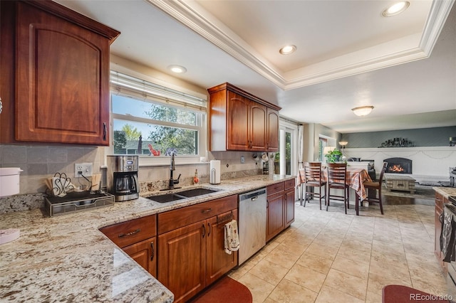9926 W Nova Pl, Littleton, CO 80127 - kitchen featuring stainless steel dishwasher, plenty of natural light, light stone countertops, tasteful backsplash, and recessed lighting