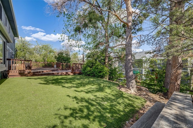 9926 W Nova Pl, Littleton, CO 80127 - view of grassy yard with a wooden deck