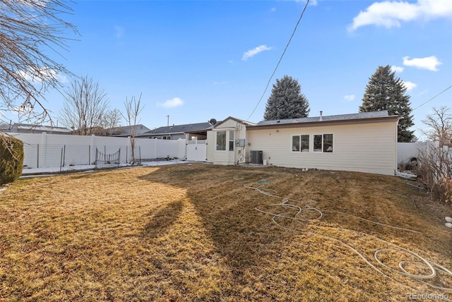 back of house featuring a yard and central air condition unit