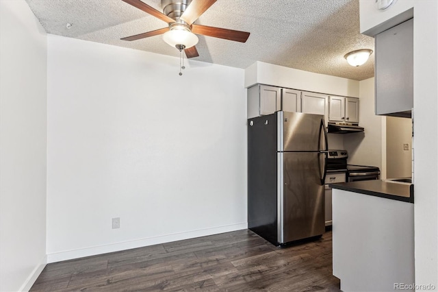 kitchen with appliances with stainless steel finishes, dark hardwood / wood-style flooring, gray cabinets, and a textured ceiling