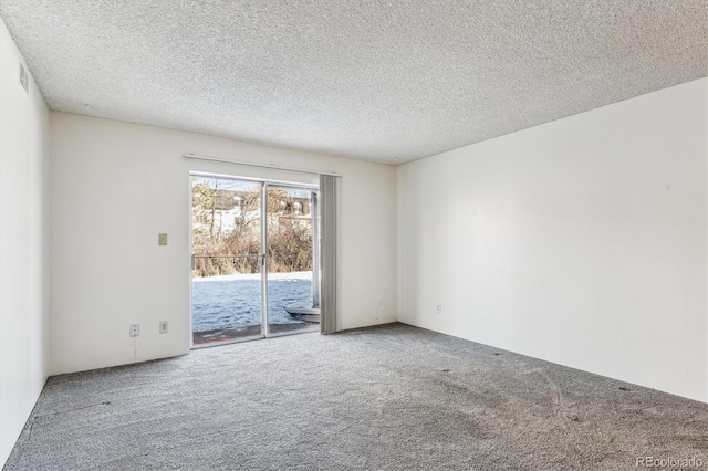 carpeted empty room with a textured ceiling