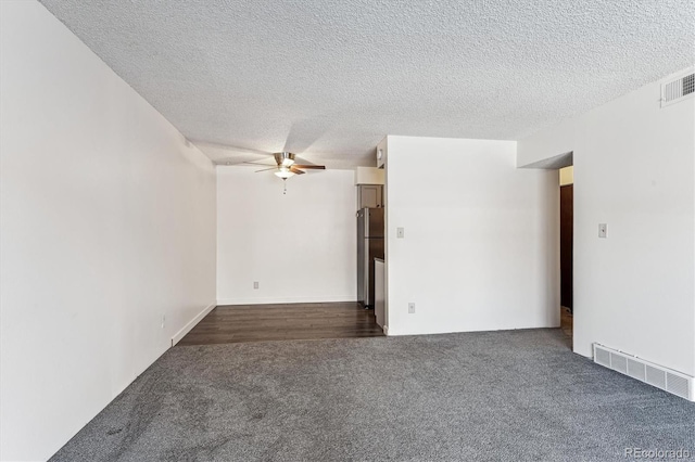 carpeted empty room featuring a textured ceiling and ceiling fan