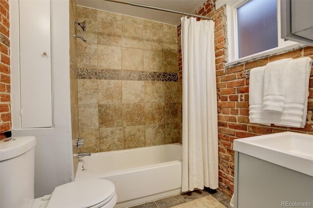 full bathroom with toilet, brick wall, and shower / bathtub combination with curtain