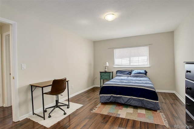 bedroom with wood finished floors and baseboards