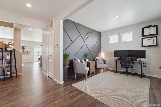 home office with dark wood-type flooring and a wealth of natural light