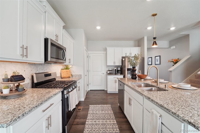 kitchen featuring stainless steel appliances, white cabinetry, tasteful backsplash, and sink