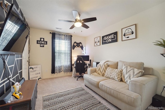 carpeted living room featuring ceiling fan