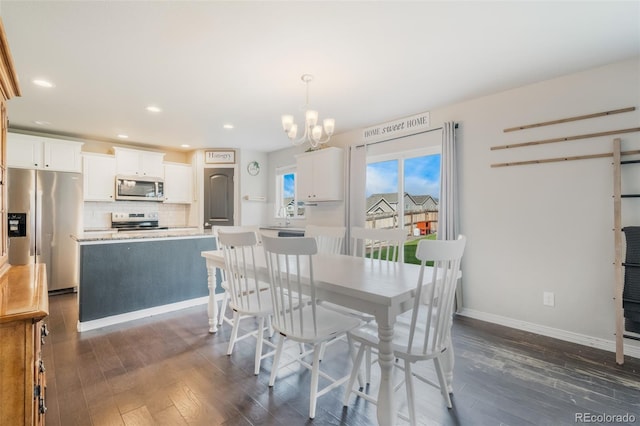 dining room with an inviting chandelier, dark wood-type flooring, and sink