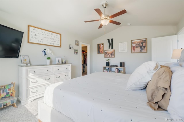 bedroom with a closet, lofted ceiling, light carpet, a spacious closet, and ceiling fan