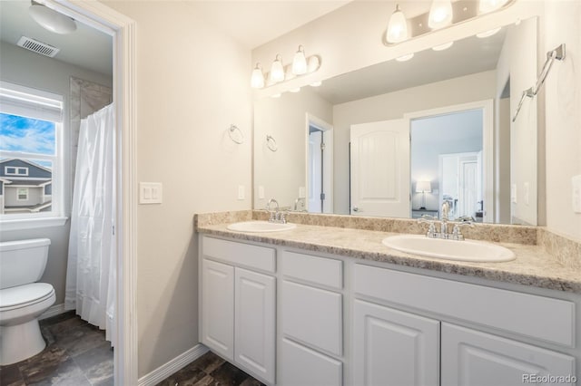 bathroom with vanity and toilet