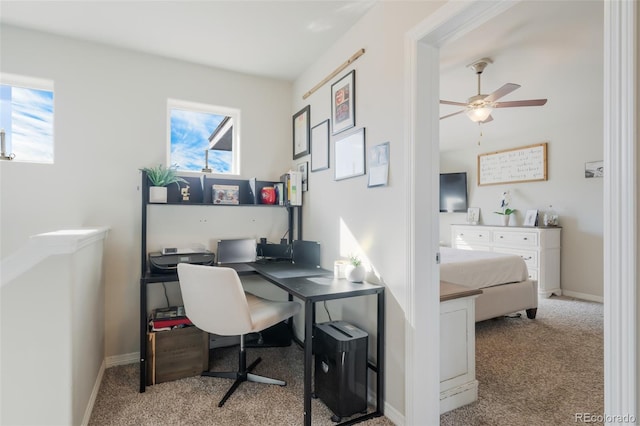 carpeted home office featuring ceiling fan