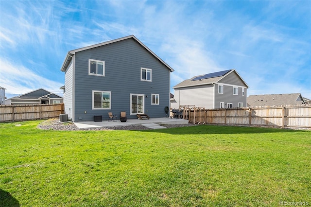 back of property featuring a lawn, central AC, and a patio area