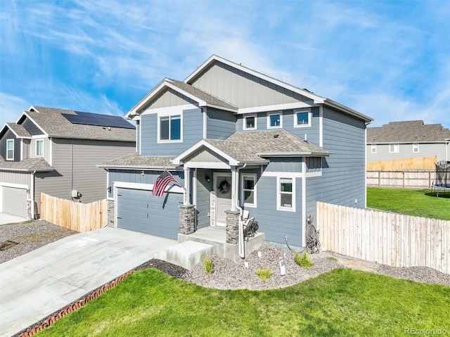 craftsman-style house featuring a front lawn and a garage