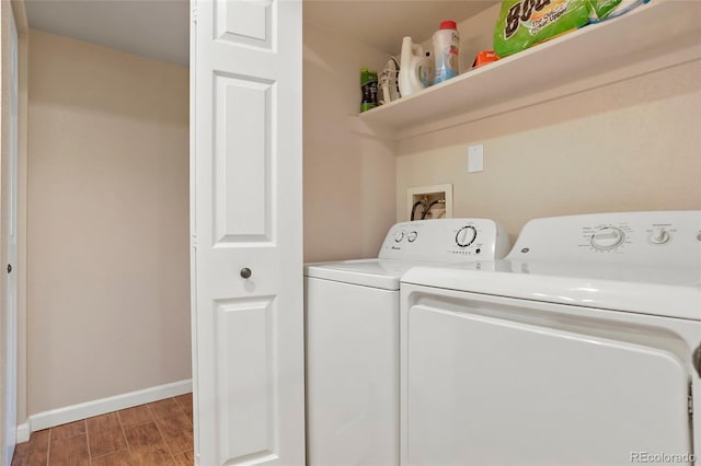 laundry area with washing machine and clothes dryer and wood-type flooring