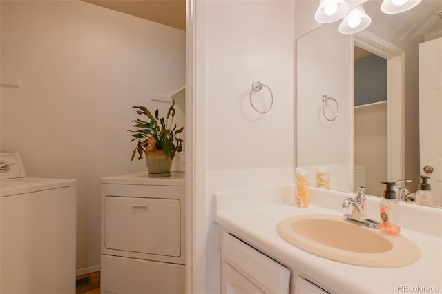 bathroom featuring vanity and washer and dryer