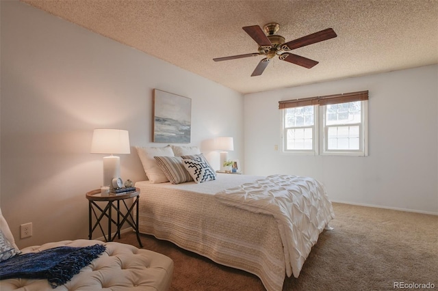 bedroom with a textured ceiling, carpet, and ceiling fan