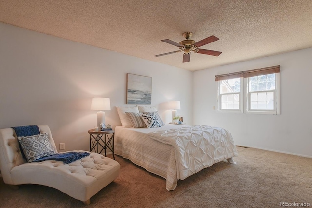 carpeted bedroom with a textured ceiling and ceiling fan