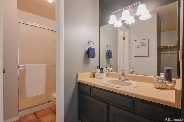 bathroom with vanity, toilet, and tile patterned flooring