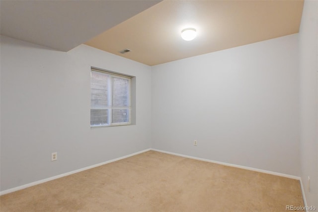 unfurnished room featuring light colored carpet