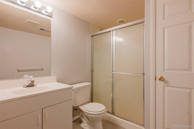 bathroom featuring vanity, toilet, and an enclosed shower