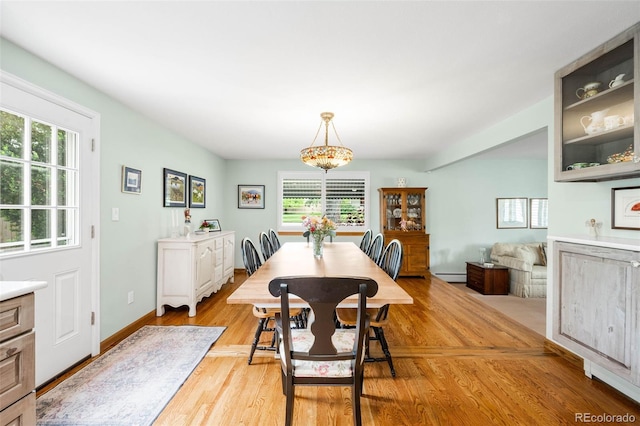 9765 W 77th Dr, Arvada, CO 80005 - dining area with light wood-type flooring, a baseboard heating unit, and baseboards