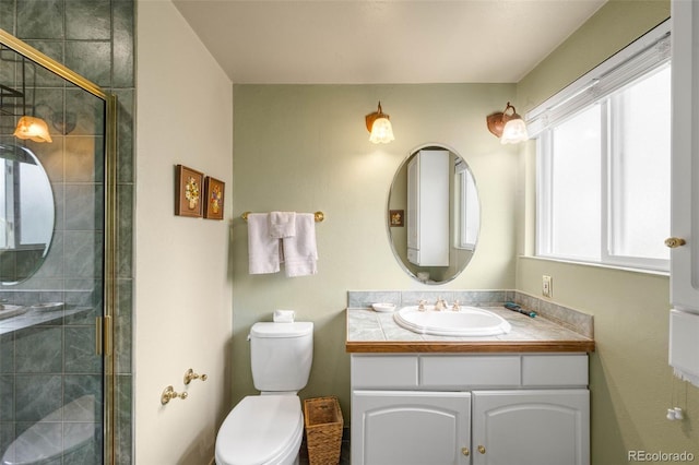 9765 W 77th Dr, Arvada, CO 80005 - bathroom featuring vanity, toilet, and a tile shower