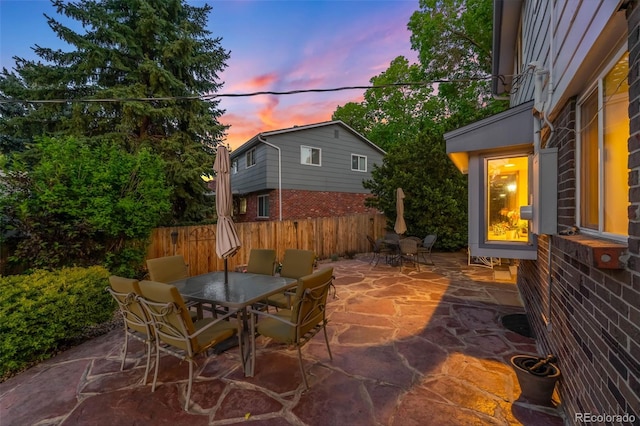 9765 W 77th Dr, Arvada, CO 80005 - patio terrace at dusk featuring outdoor dining space and a patio area
